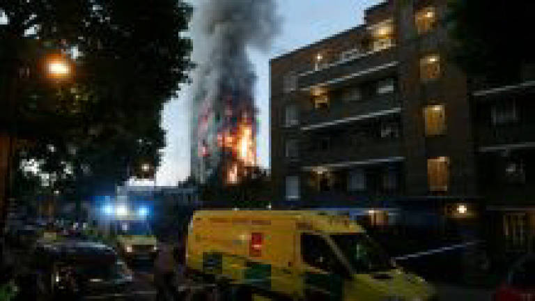 Grim search for bodies in gutted London tower block