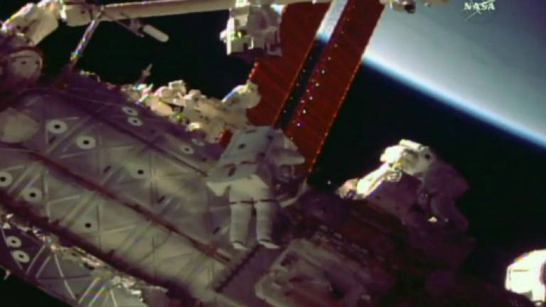 Japanese, US astronauts on spacewalk to fix robotic arm