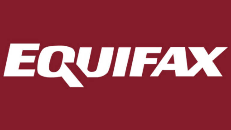 Equifax offers apology for hack amid sinking earnings