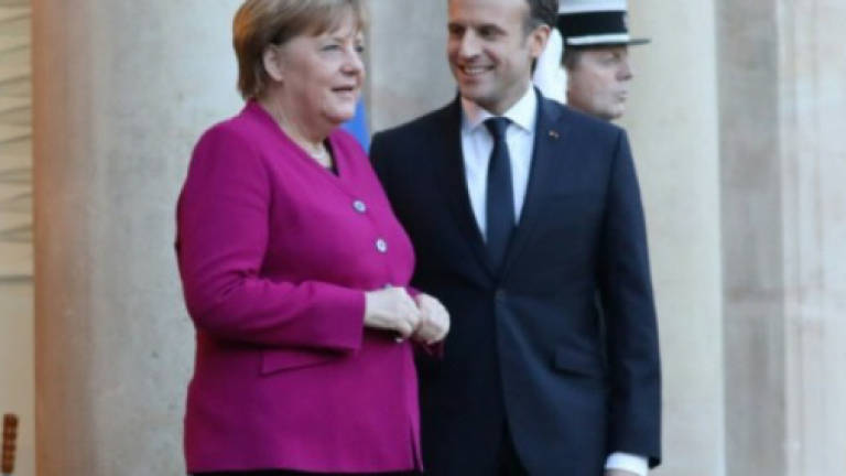 Macron boosts Merkel ahead of key coalition vote