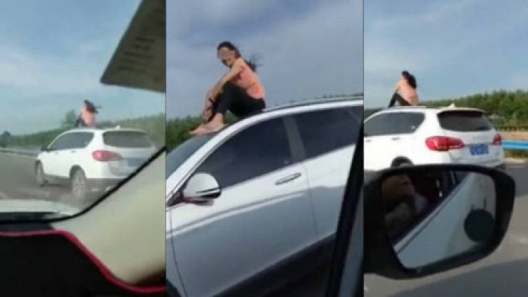 (Video) Car-surfing woman let off with RM6 fine