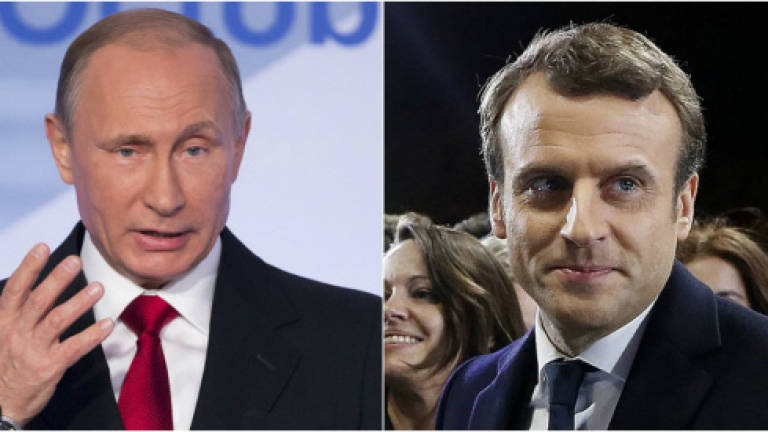 Putin urges Macron to shed mutual distrust and 'join forces'