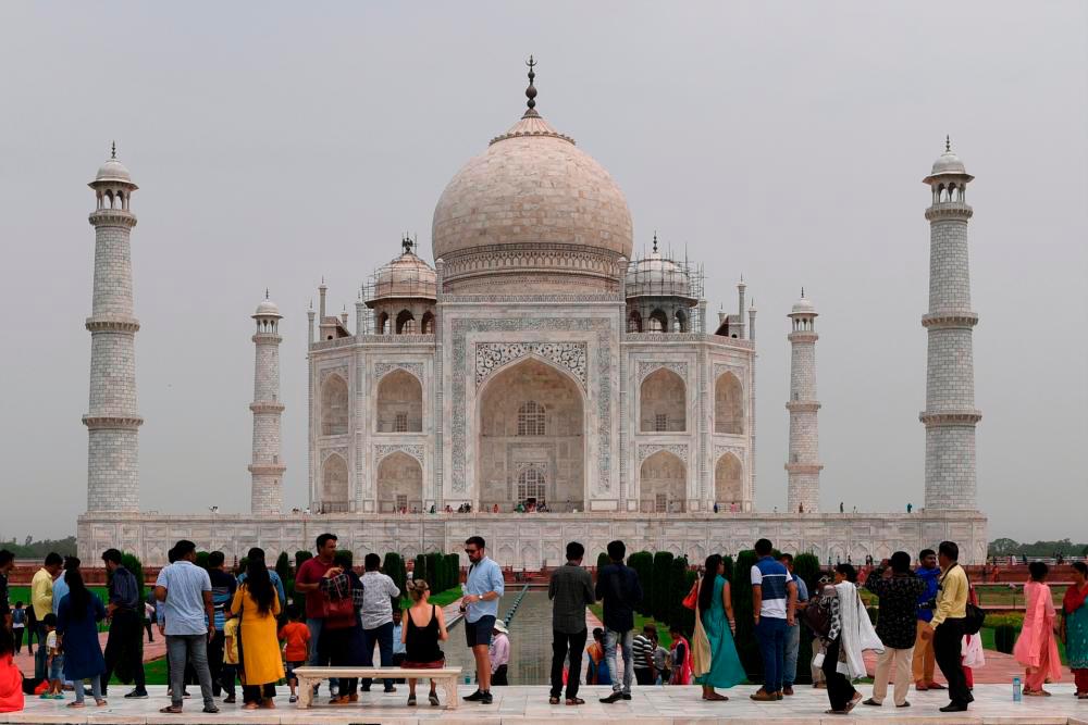 Tourists visit the Taj Mahal in Agra/AFPPix