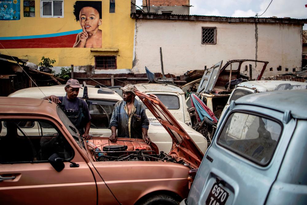Elyse Rakotondrakonona (right) in front of a Renault 4L in his workshop in Antananarivo’s Antoamadikina neighbourhood, on Nov 6. The iconic French car was in production between 1961 and 1992 and till 1994 in Slovenia.
