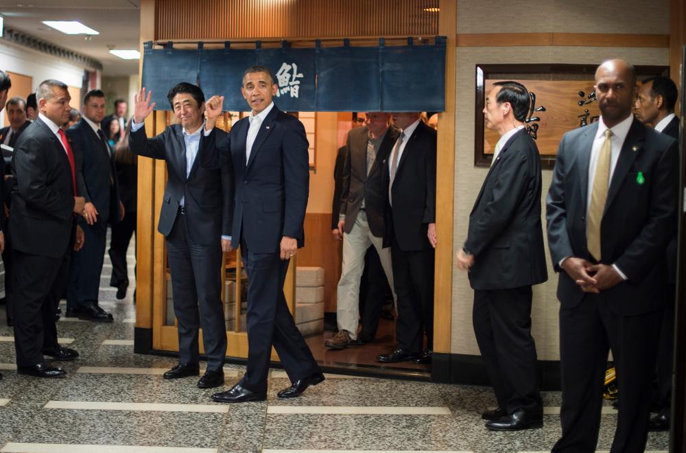 This file photo taken on April 23, 2014 shows US President Barack Obama (C) and Japan’s Prime Minister Shinzo Abe (2nd L) departing after a private dinner at the Sukiyabashi Jiro restaurant in Tokyo. © Jim WATSON / AFP