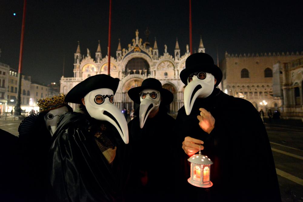 Masked revellers take part in the ‘Plague Doctors’ Procession on Saint Mark Square in Venice on February 25, 2020. Other Carnival festivities have been cancelled following an outbreak of the COVID-19 novel coronavirus in northern Italy. © ANDREA PATTARO / AFP