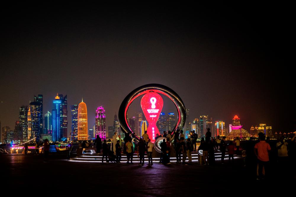 $!Visitors gather at the FIFA World Cup countdown clock in Doha. – AFPPIX