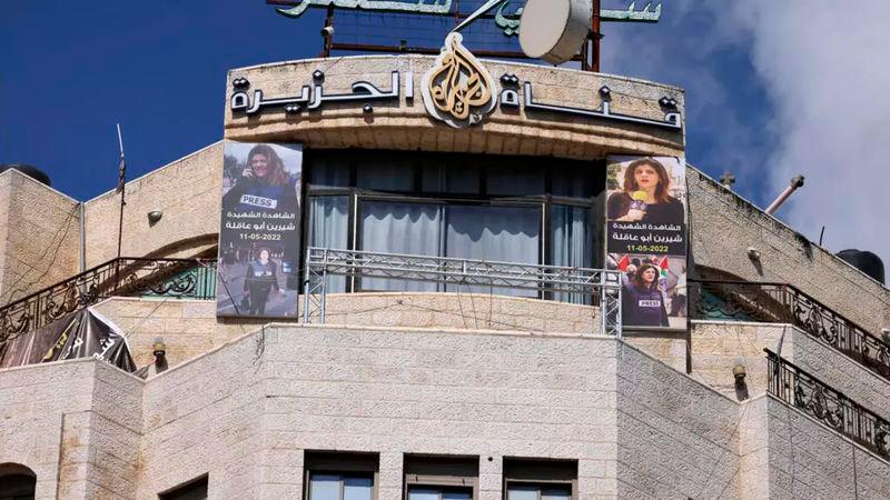 Pictures of slain al-Jazeera journalist Shireen Abu Akleh hang on the facade of the building housing the television station’s office in Ramallah in the occupied West Bank after Israel issued a 45-day closure order on September 22, 2024. © Jaafar Ashtiyeh, AFP