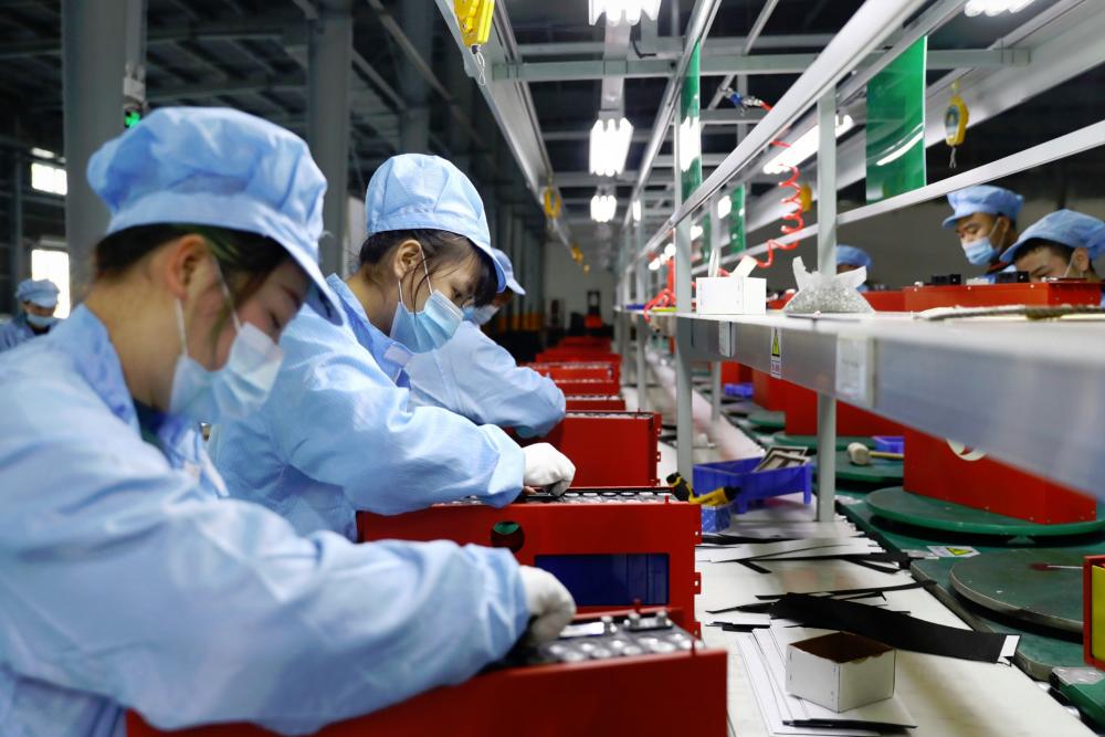 Employees working in the workshop of a lithium battery manufacturing company in Huaibei, eastern China’s Anhui province.