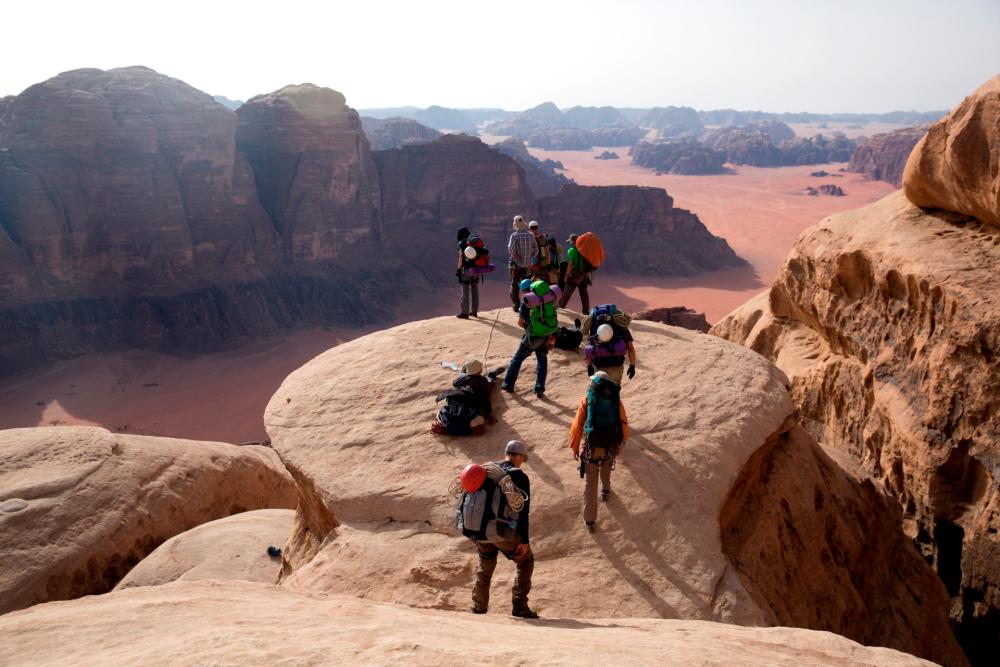 A group of Israeli hikers climb down from the peak of Jabel Rum (Mount Rum) in the southern Jordanian desert in an area known as Wadi Rum or the Valley of the Moon© MENAHEM KAHANA / AFP