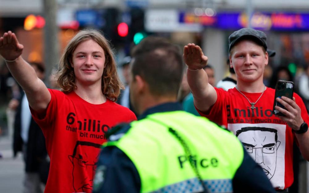Members of the National Socialist Network perform Nazi salutes during a protest rally in Melbourne on June 4, 2023.