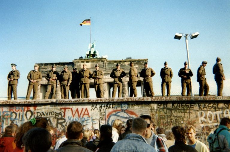 Three days after Schabowski’s announcement, on November 11, crowds gathered at the wall as border guards watched. — AFP