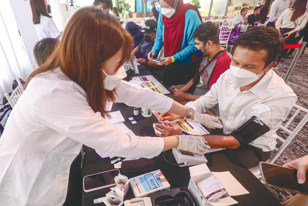 Caring Pharmacy staff will be at hand at its outlets nationwide to assist the public with the CariDoctor platform services. – AMIRUL SYAFIQ/THESUN