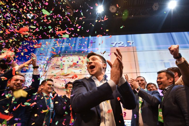 Volodymyr Zelensky celebrates with his supporters after the announcement of exit polls of the presidential elections at his campaign headquarters in Kiev on April 21, 2019. — AFP