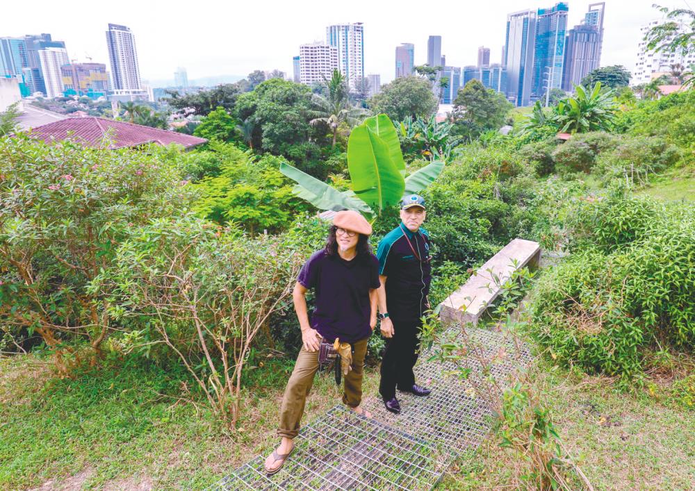 Ng (left) showing Nadzim around at the farm in Bangsar, Kuala Lumpur. – HAFIZ SOHAIMI/THESUN