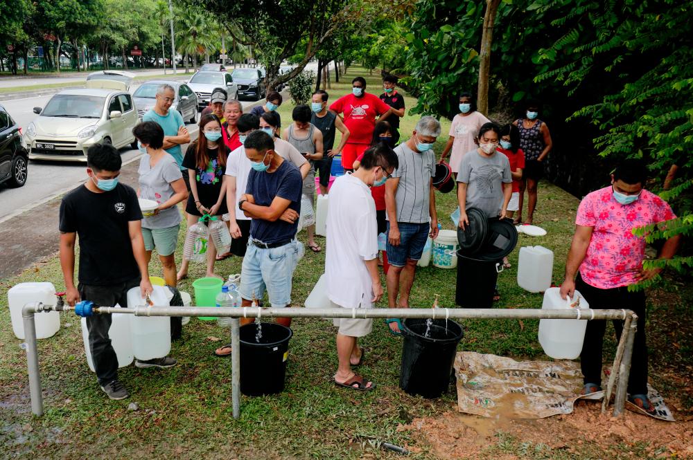 $!Residents in Subang Jaya, Selangor queuing to collect water from a relief supply station. – ASYRAF RASID/THESUN