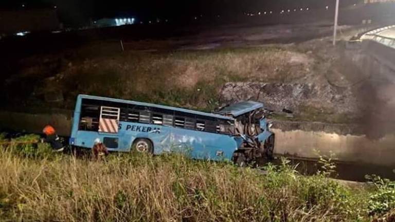 The bus that plunged into a drain near the MASKargo area in Sepang. — Facebook photo
