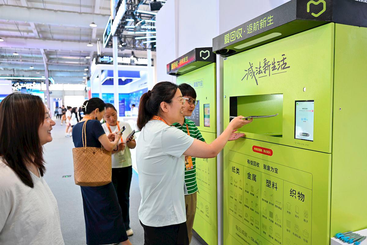 Visitors learn about an intelligent recycling machine at the 2025 China International Fair for Trade in Services (CIFTIS) in Beijing, capital of China, Sept. 12, 2025. The 2025 CIFTIS opened in Beijing on Wednesday, themed “Embrace Intelligent Technologies, Empower Trade in Services.” The participating enterprises present their latest technological achievements, showcasing experiences in green and low-carbon development. (Xinhua/Li Xin)