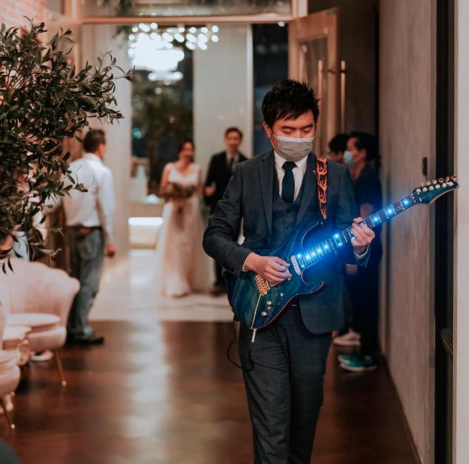 $!Eugene performs with his LED Guitar while walking into the venue, and this also marks the grand entry of the groom and bride.