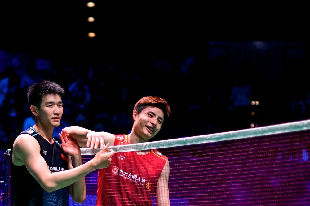 Winner China’s Li Shi Feng (left) congratulates China’s Yu Qi Shi at the end of the Men’s Singles Final at the All England Open Badminton Championships at the Utilita Arena in Birmingham March 19, 2023. — AFP pic