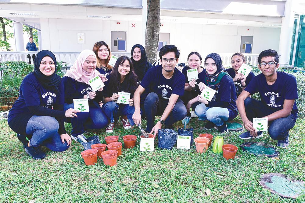 Mohd Imamul (front row, fourth from left) and members of the Sunway Environmental Society at the seed-planting session.