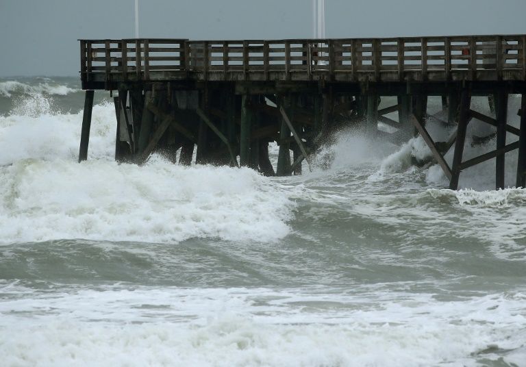 Heavy surf caused by the approach of Hurricane Dorian pounds the boardwalk on September 3, 2019 in Daytona Beach, Florida. — AFP