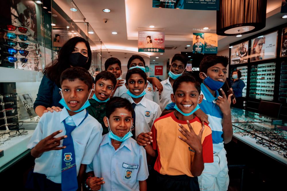 $!Sangeeta and the children at the Focus Point outlet. – COURTESY OF SANGEETA KRISHNASAMY