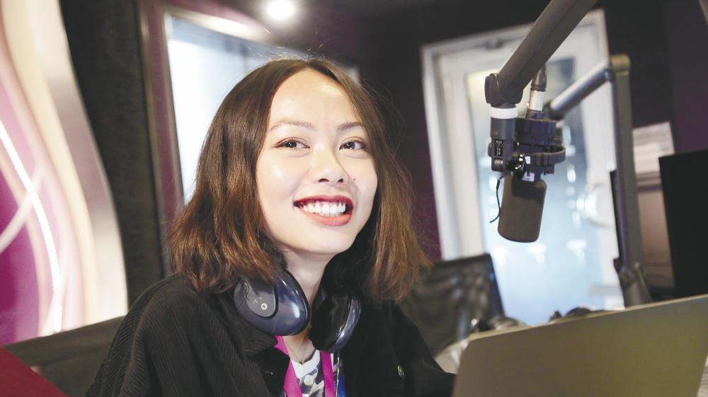 Zher at work in her booth at the radio station. – Courtesy of Tham Zher Peen $!Zher at work in her booth at the radio station. – Courtesy of Tham Zher Peen