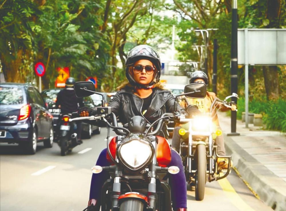 $!She learned how to ride a bike in order to travel around the country for the travelogue show KL to KK. – Courtesy of Hemalata Gnanaprakasam