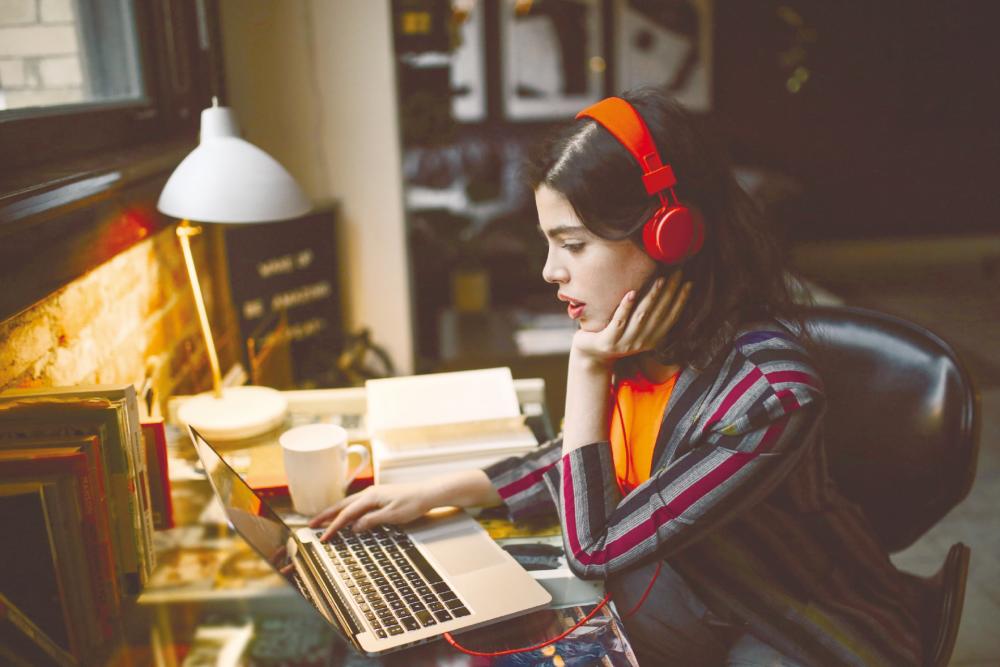 Research shows that listening to music can improve concentration and boost mental performance in the office. – IStock.com