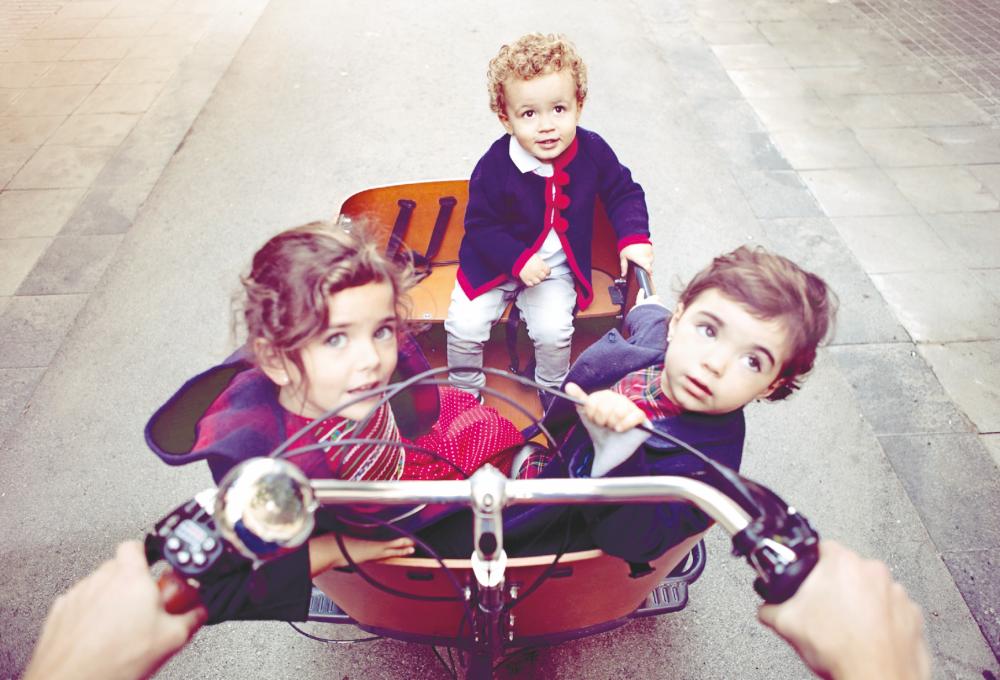 A cargo bike can be a practical solution for transporting kids. – IStock.com