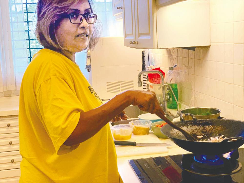 Padma Zachariah whipping up a meal in her kitchen. – Courtesy of Padma Zachariah