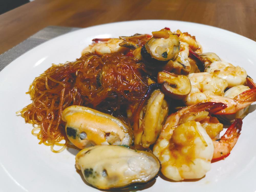$!A plate of stir fried glass noodles with prawns, mussels and button mushrooms by Mah. – Courtesy of Xavier Mah