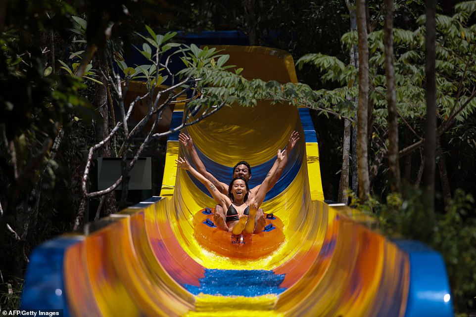 Spanning 3,645ft, the blue and yellow chute will see thrill-seekers mount an inflatable tube before hurtling through the four-minute-long ride. - AFP