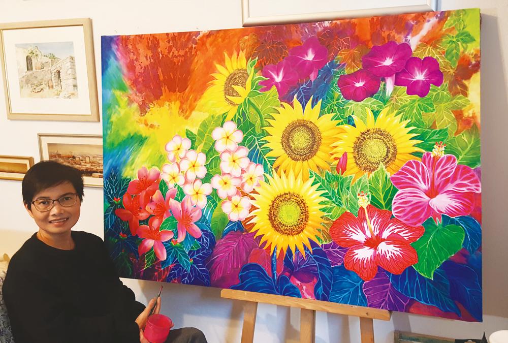 Narong pictured here working on a painting. $!Narong pictured here working on a painting.