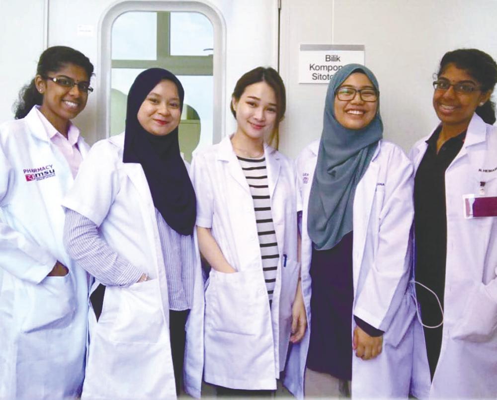 Nur Khalidah (second from left) with fellow Pharmacy students at MSU.