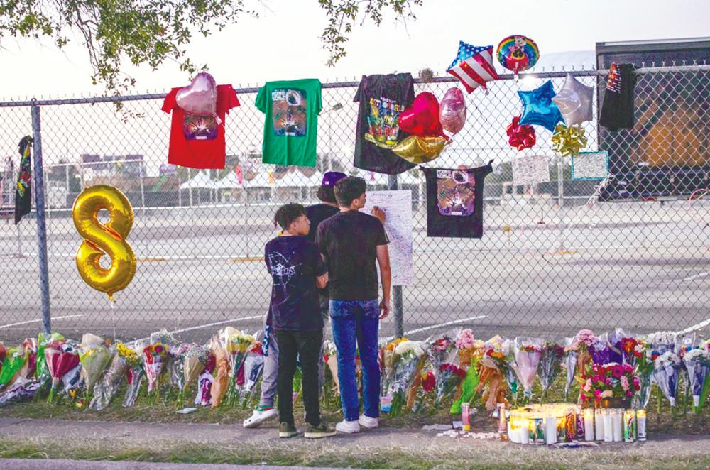 A group of teens leaving messages at a memorial outside NRG Park, where the tragedy occured. – Getty