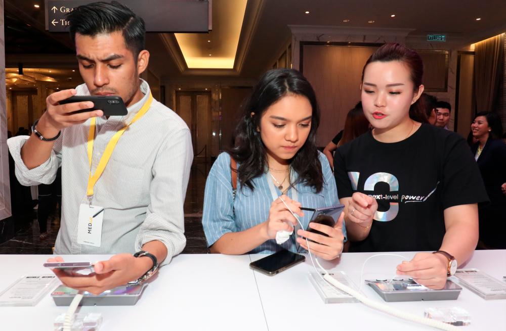 At the media event ... Members of the media exploring the various features of the upcoming Samsung Galaxy Note10. – MASRY CHE ANI/THESUN