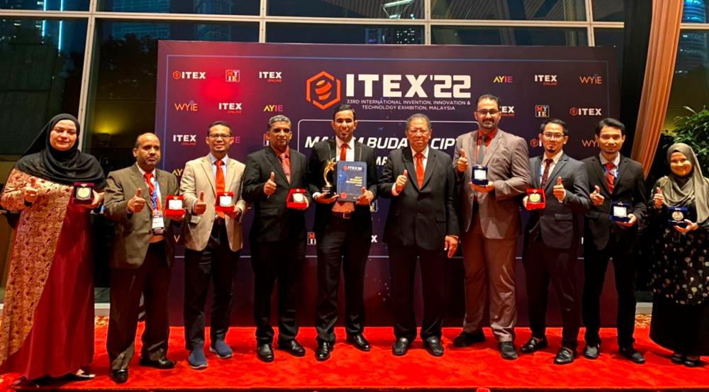 MSU researchers team for ITEX 2022 with their medals.