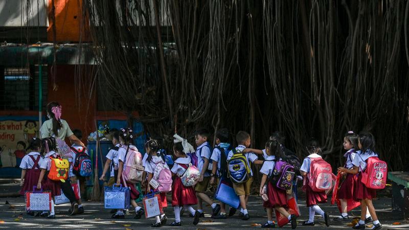 Students leave school in Manila after classes are suspended due to extreme heat © Jam STA ROSA / AFP