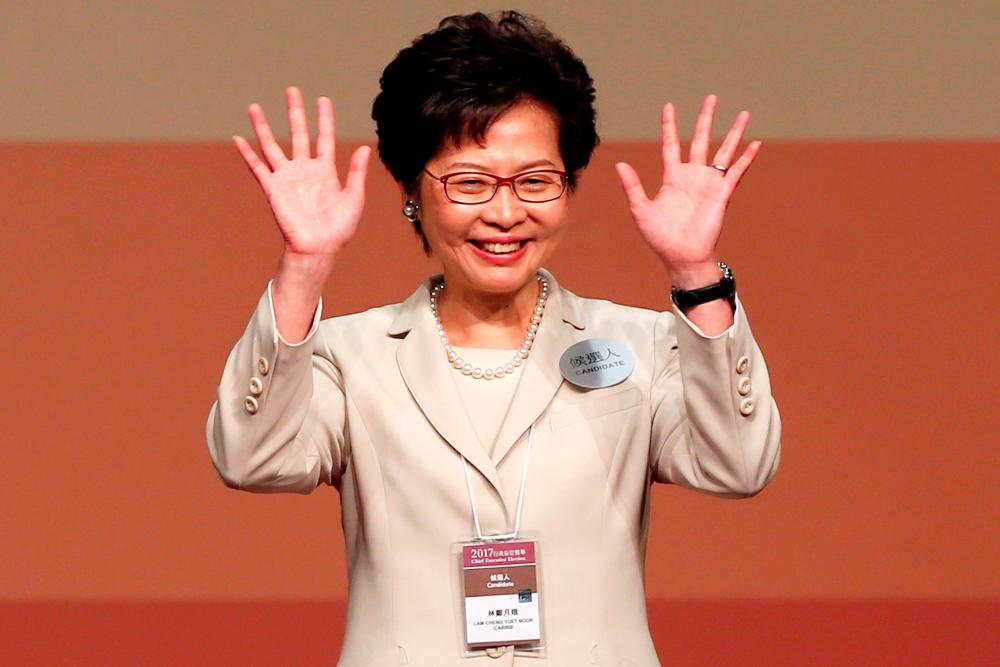 Carrie Lam waves after she won the election for Hong Kong's Chief Executive in Hong Kong, China Mar 26, 2017. — Reuters