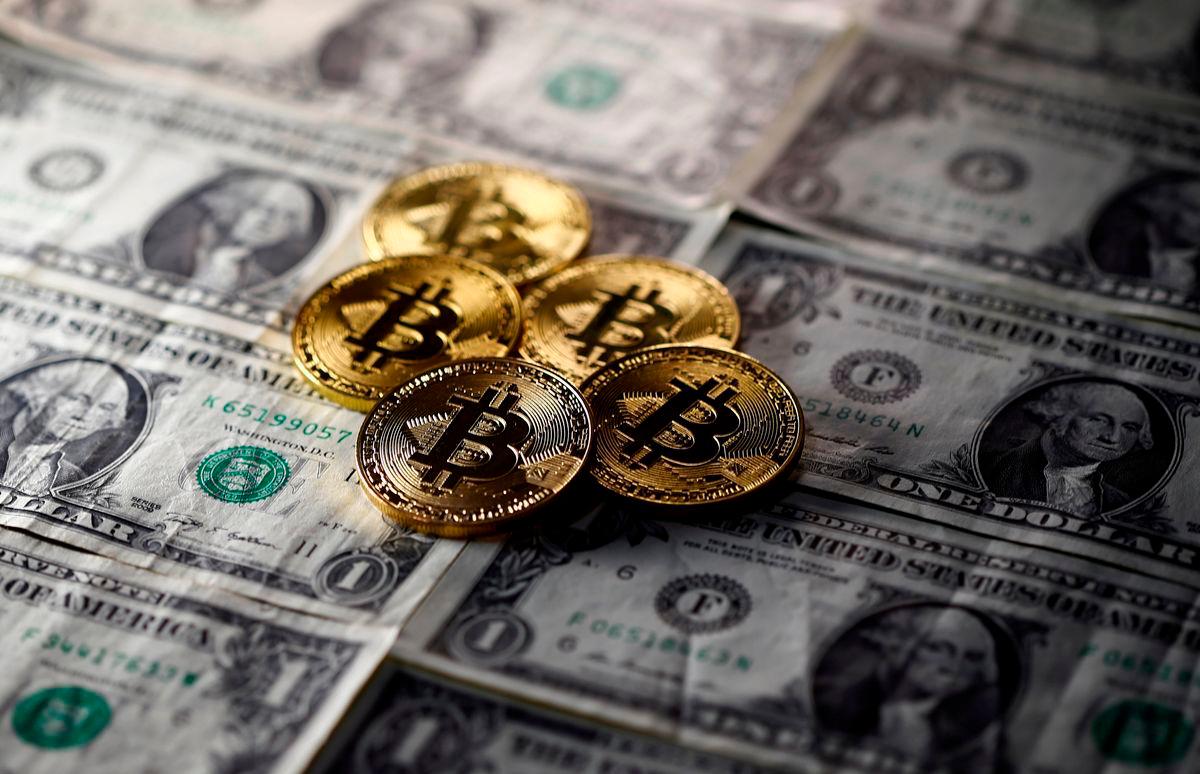 FILE PHOTO: Bitcoin (virtual currency) coins placed on Dollar banknotes are seen in this illustration picture, November 6, 2017. REUTERS