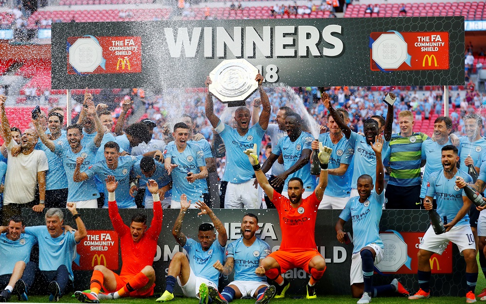 Manchester City celebrate winning the community shield with the trophy at the Wembley Stadium in London, on Aug 5, 2018. — Reuters