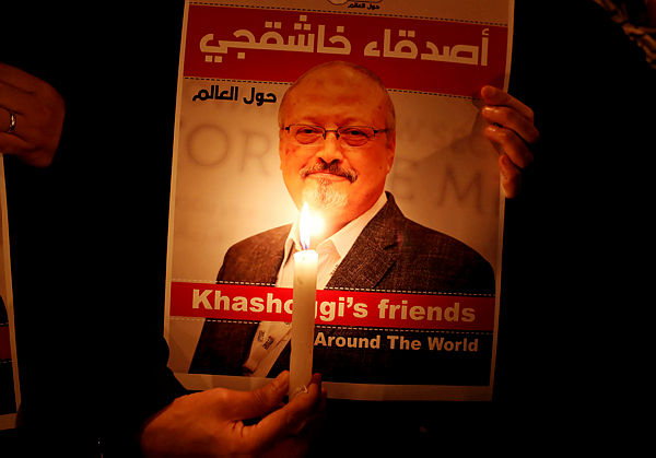 A demonstrator holds a poster with a picture of Saudi journalist Jamal Khashoggi outside the Saudi Arabia consulate in Istanbul, Turkey Oct 25, 2018. — Reuters