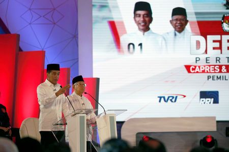 Indonesia’s presidential candidate Joko Widodo speaks next to his running mate Ma’ruf Amin, during a televised debate with his opponents Prabowo Subianto and Sandiaga Uno (not pictured) in Jakarta, Jan 17, 2019.