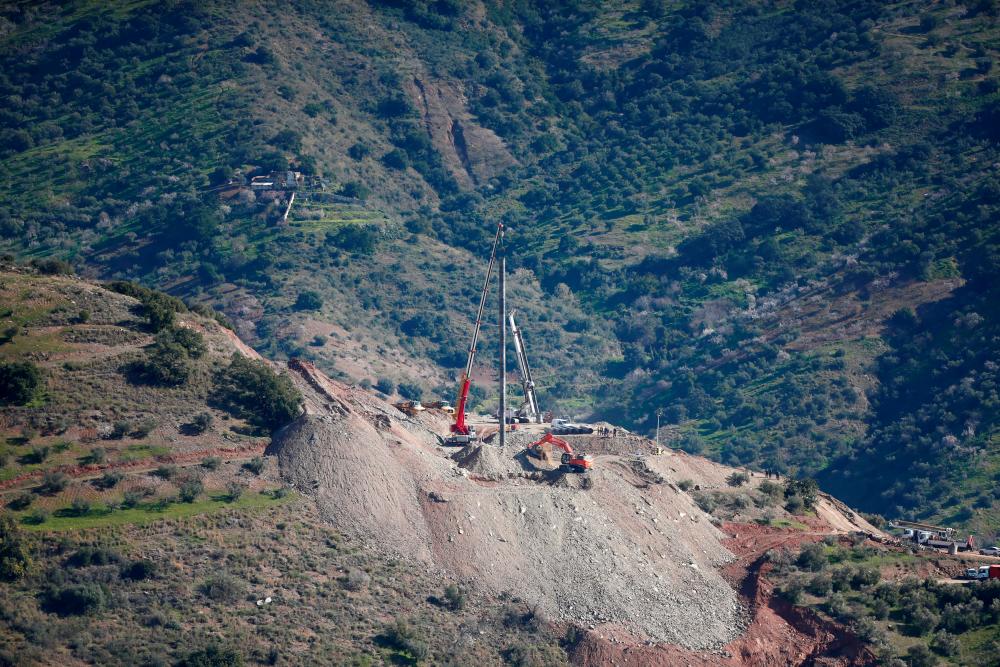 A crane removes steel tubes after failing to place them into the drilled well at the area where Julen, a Spanish two-year-old boy, fell into a deep well nine days ago when the family was taking a stroll through a private estate, in Totalan, southern Spain Jan 22, 2019. — Reuters