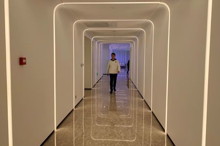 A staff member walks in the hallway during a demonstration to the media at Alibaba Group’s futuristic FlyZoo hotel in Hangzhou, Zhejiang province, China Jan 22, 2019. — AFP