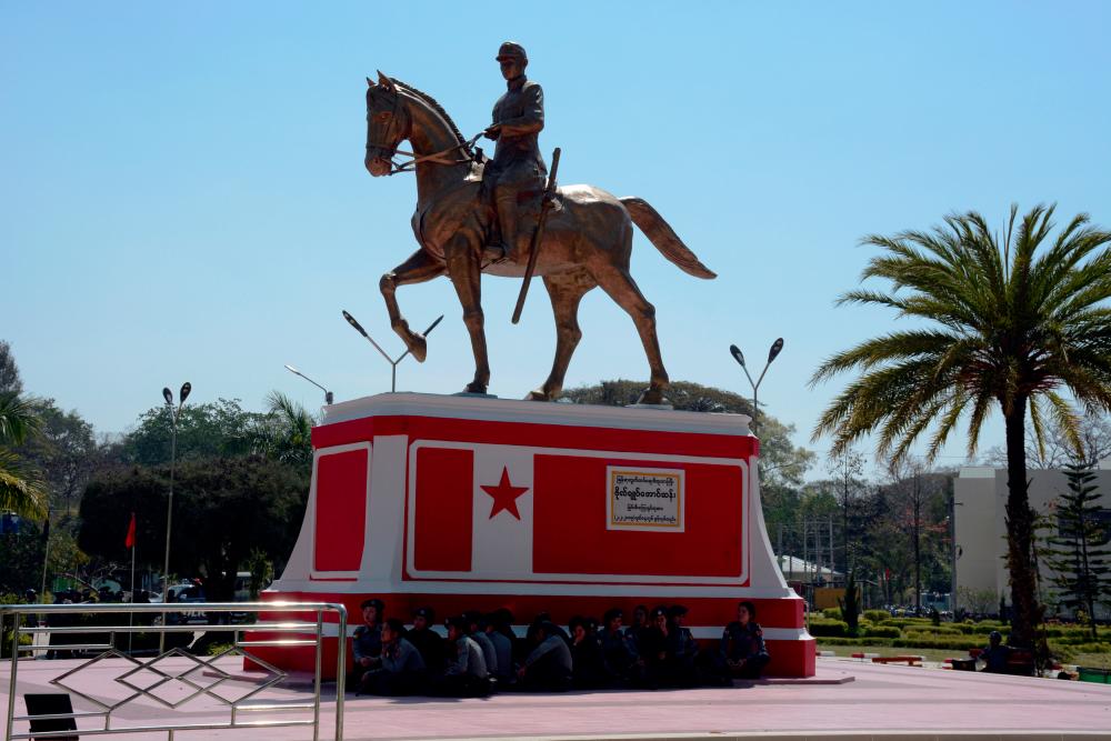 Police wait under the statue of General Aung San, Myanmar’s independence hero and the father of leader Aung San Suu Kyi in Loikaw, Kayah state, Myanmar on Feb 12, 2019. — Reuters
