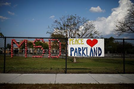 he initials of Marjory Stoneman Douglas High School and a placard are placed on the fence at Park Trails Elementary School, following a mass shooting in Parkland, Florida, US, on April 9, 2018. — AFP