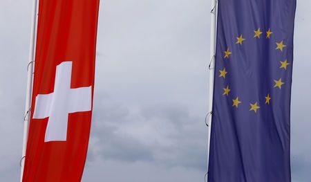 The flags of the European Union and Switzerland flutter in the wind in Blotzheim, France, on June 27, 2017. — Reuters